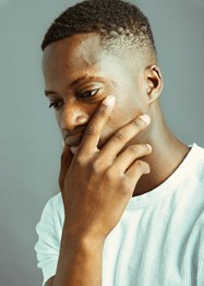 Man with hand on face