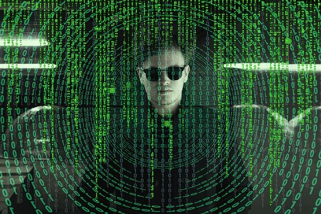 Movie clip from Matrix with green code of image of a name in sunglasses