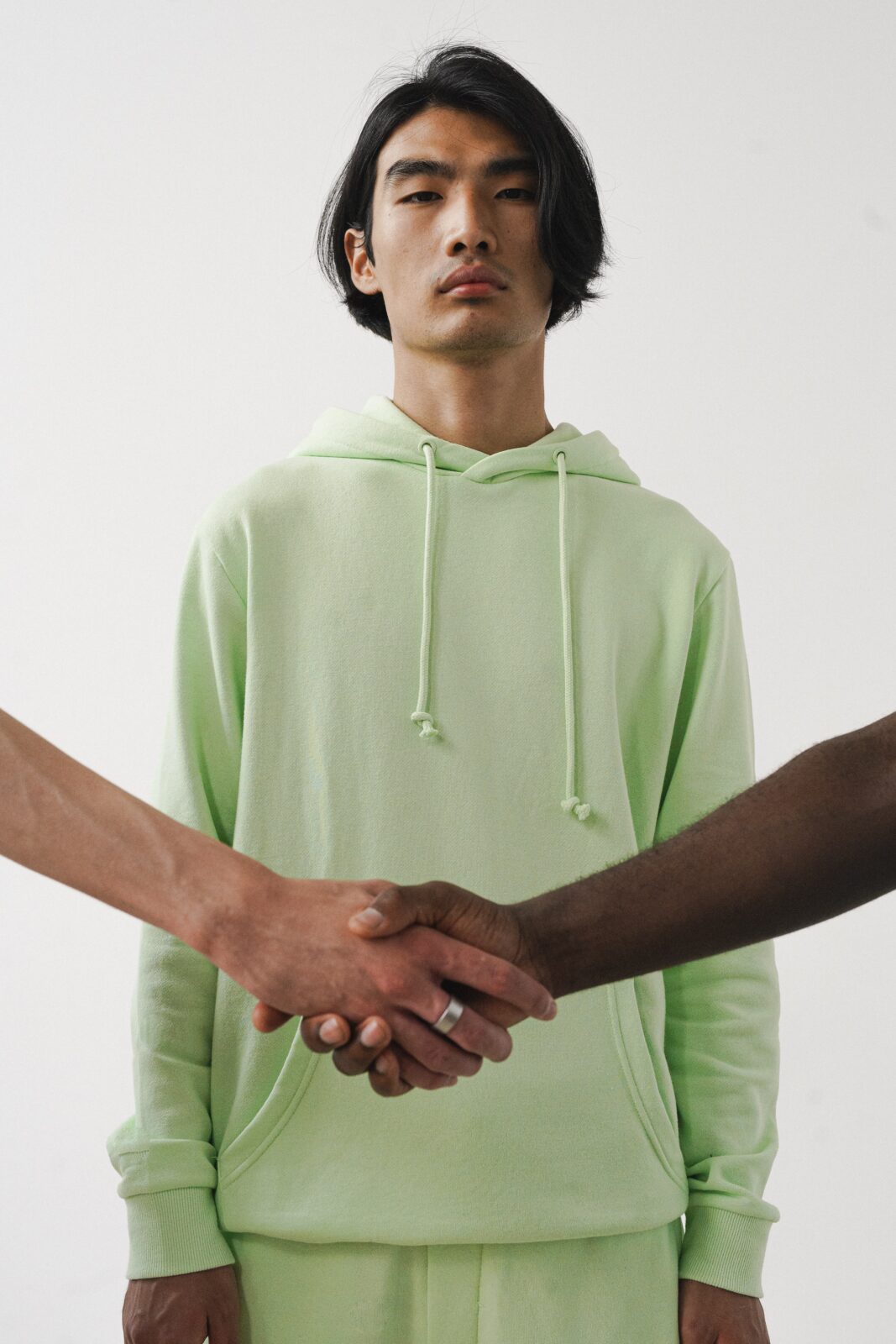 two hands shaking in front of a man